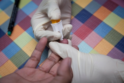 HIV finger prick testing at the Service Workers In Group (SWING) Foundation.